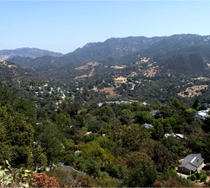 A view of a valley with mountains in the background