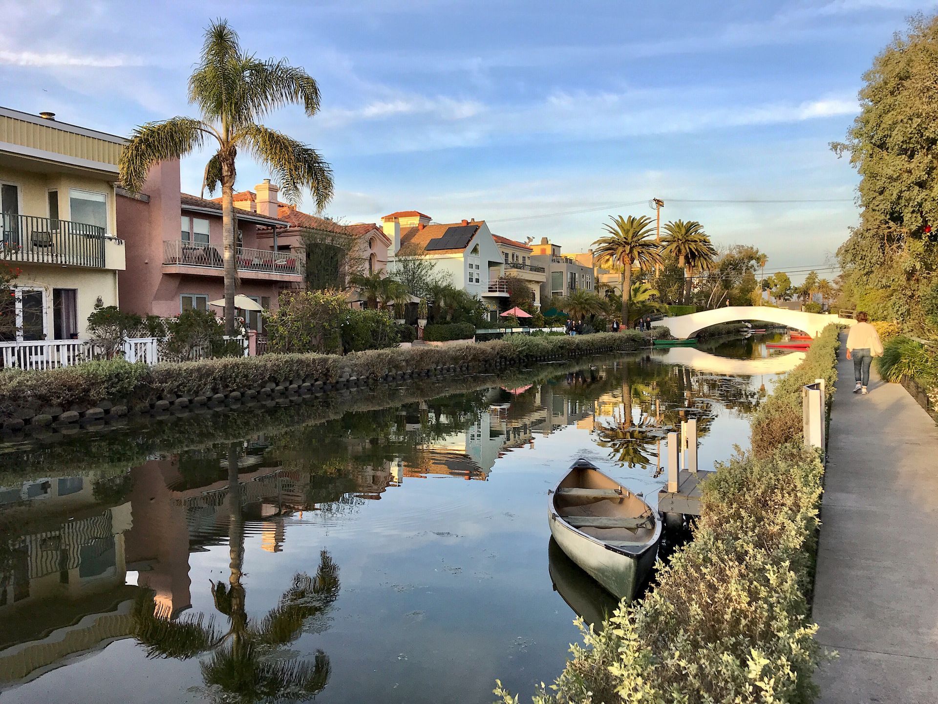 A boat is docked on the side of a river.