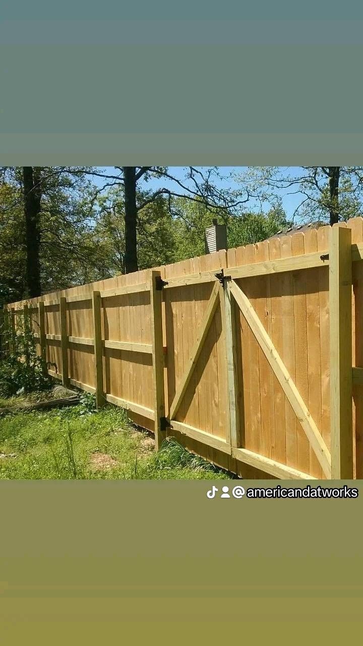 Black and silver corrugated metal fence, outdoors, surrounding property.