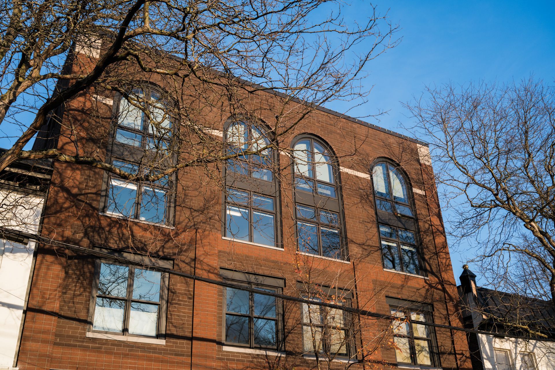 Photo showing a face of a building, looking up at it from the street view