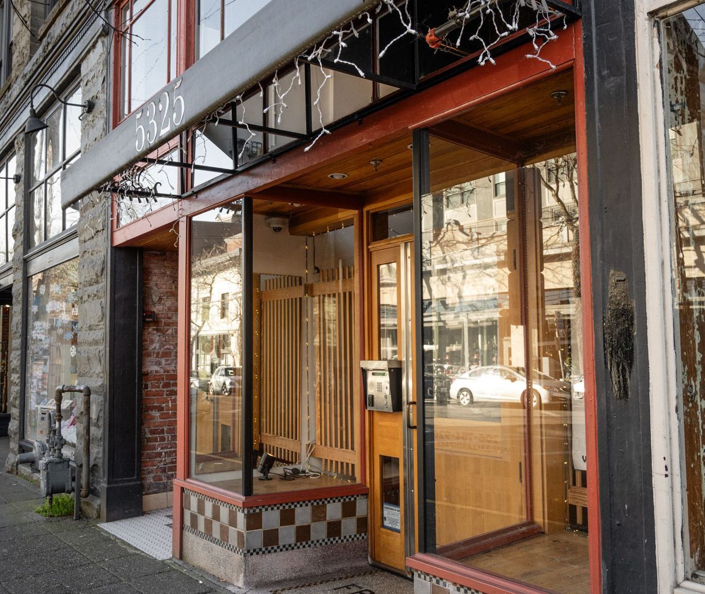 Photo showing a storefront with plenty of glass, combined with brick