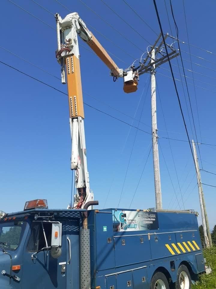 Un camion bleu avec une grue attachée