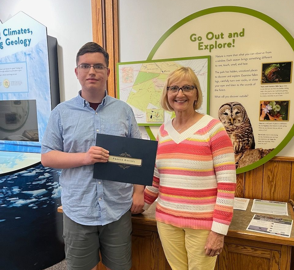 A man and two women are posing for a picture together