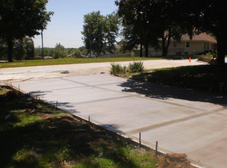 a concrete driveway is being built in front of a house