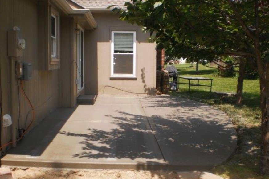 a house with a concrete patio in front of it