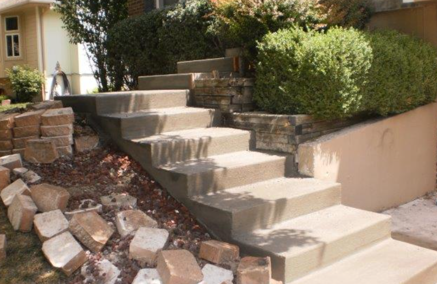 a set of concrete stairs leading up to a house