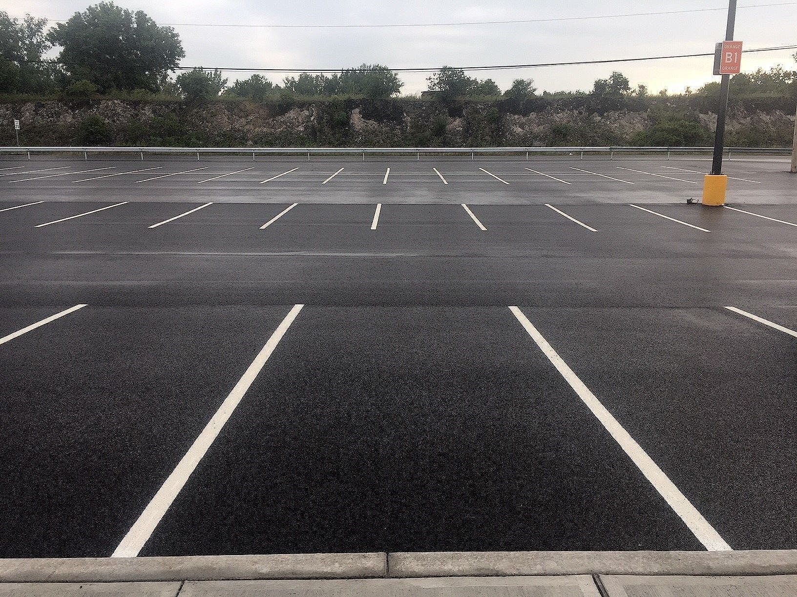an empty parking lot with white lines on it