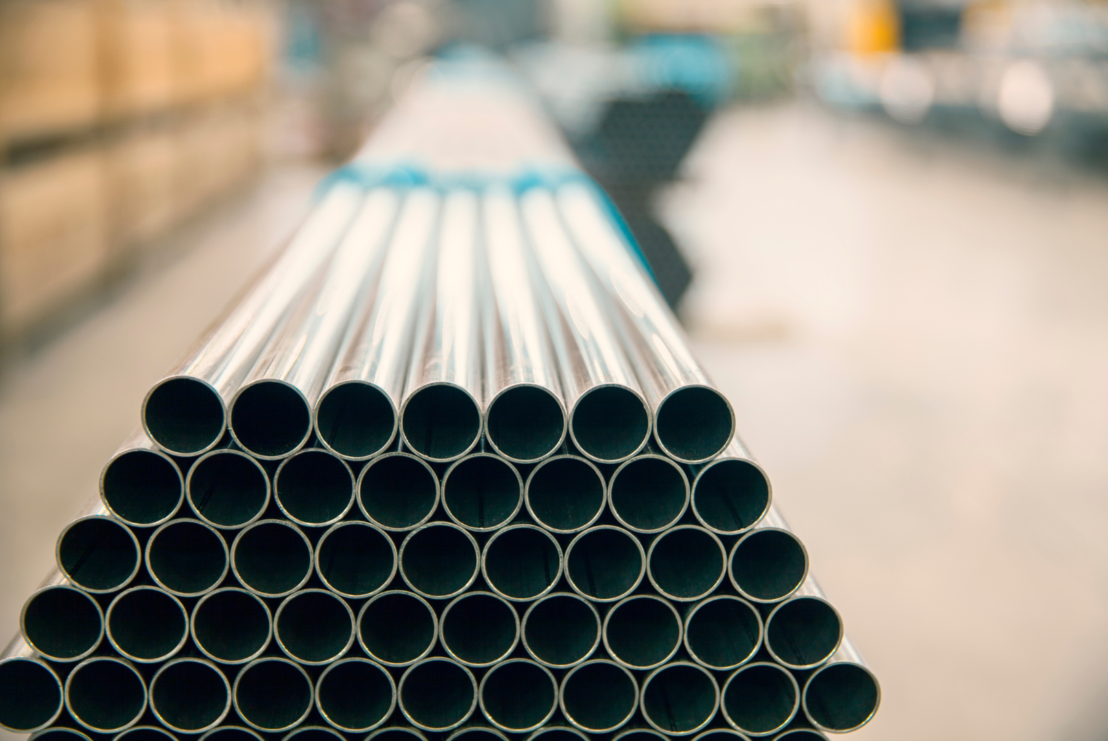 A stack of metal pipes stacked on top of each other in a factory.