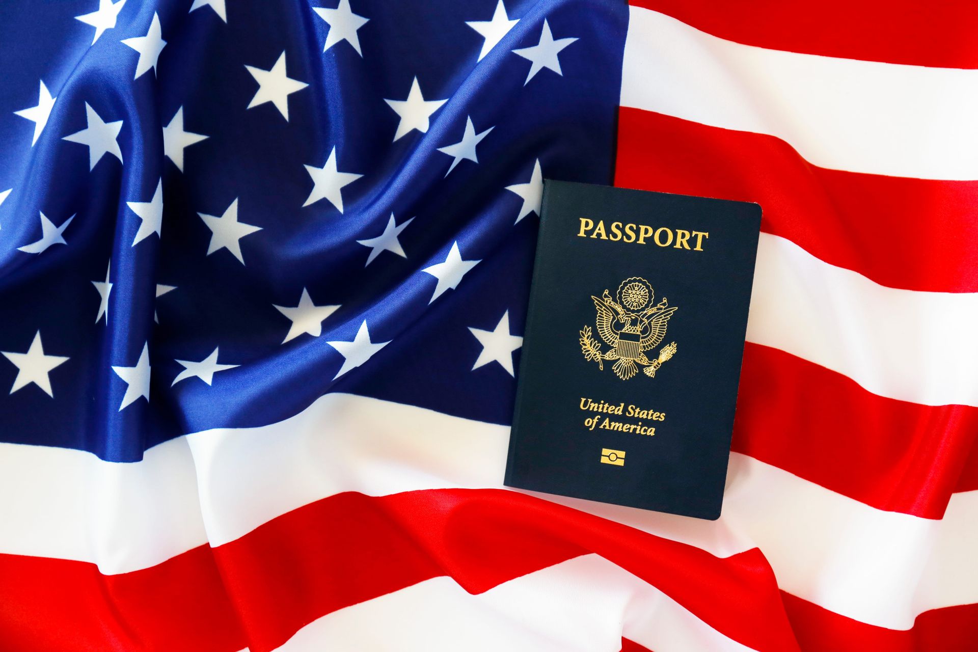 U.S. passport on a waving American flag background