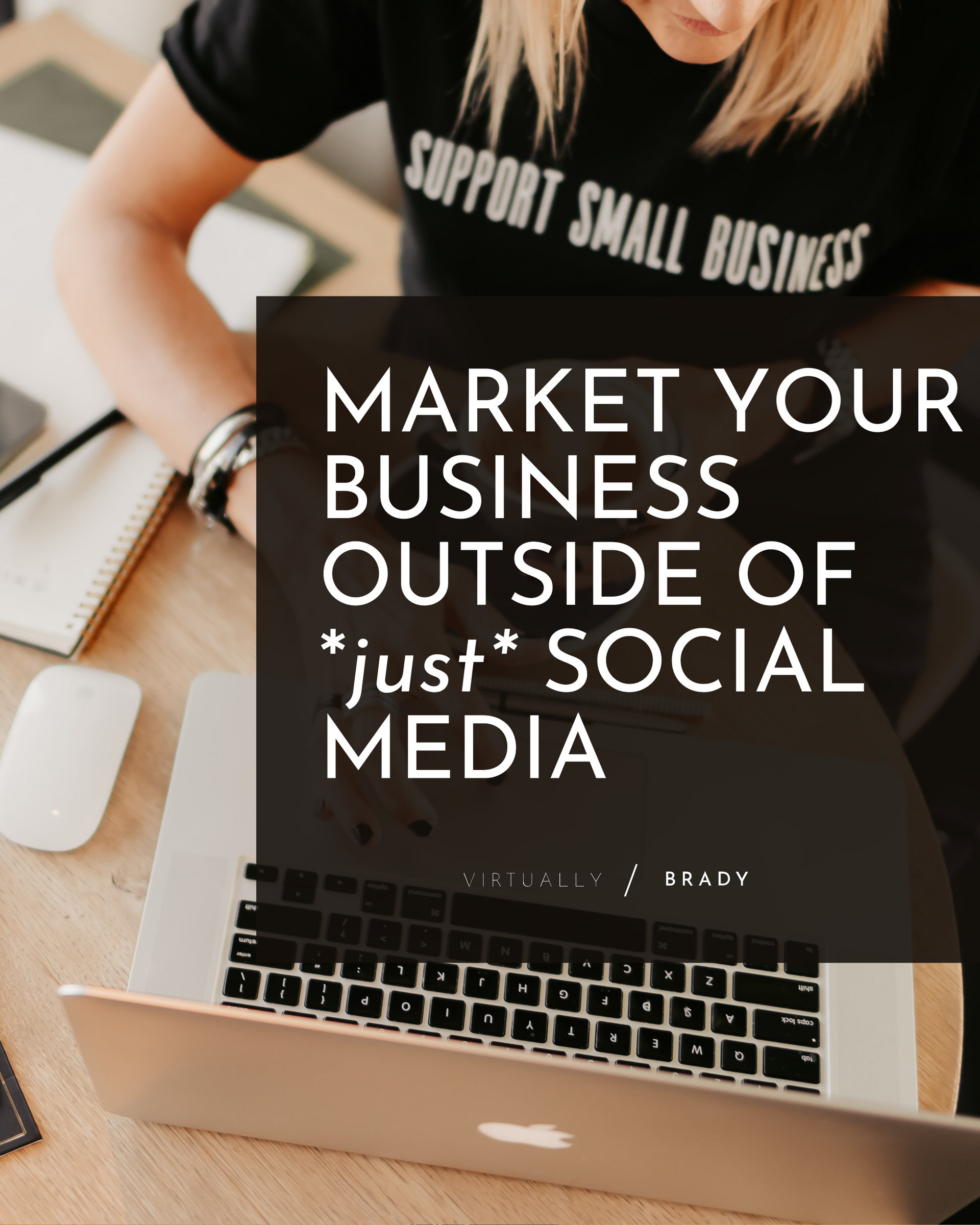 A woman is sitting at a desk with a laptop and a sign that says market your business outside of just social media