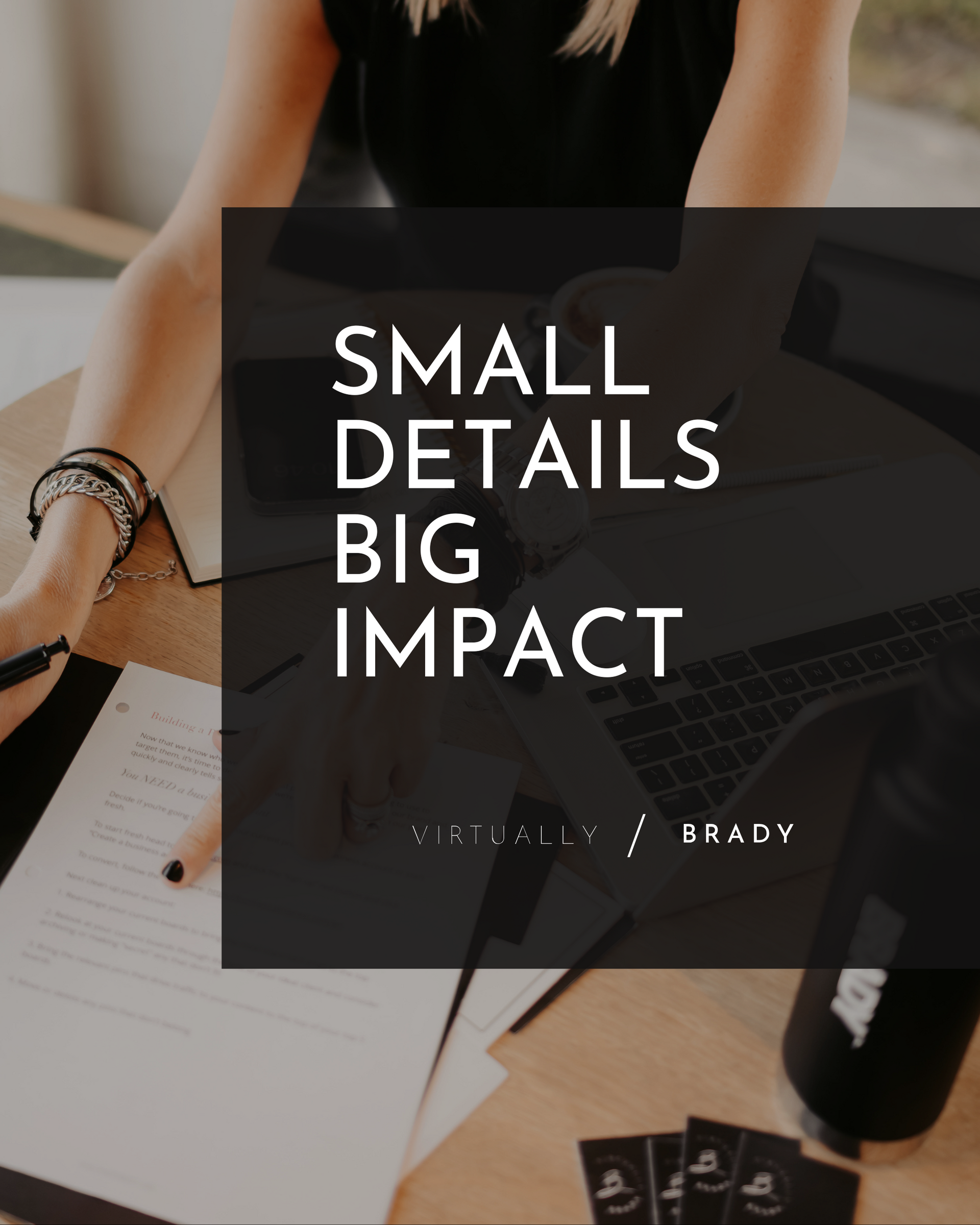 A woman is sitting at a desk with a laptop and a small details big impact poster