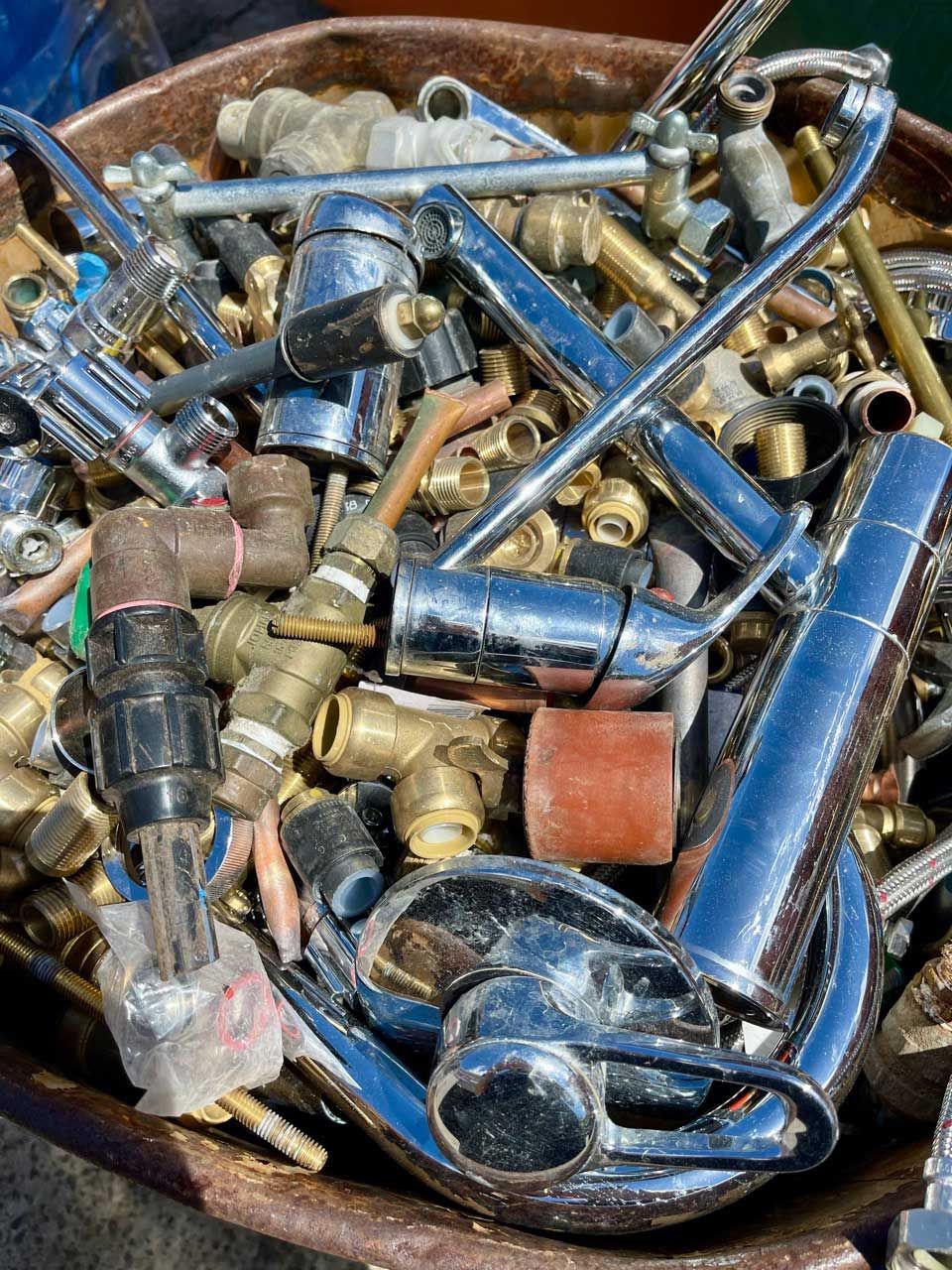 A pile of scrap metal is sitting on the ground.