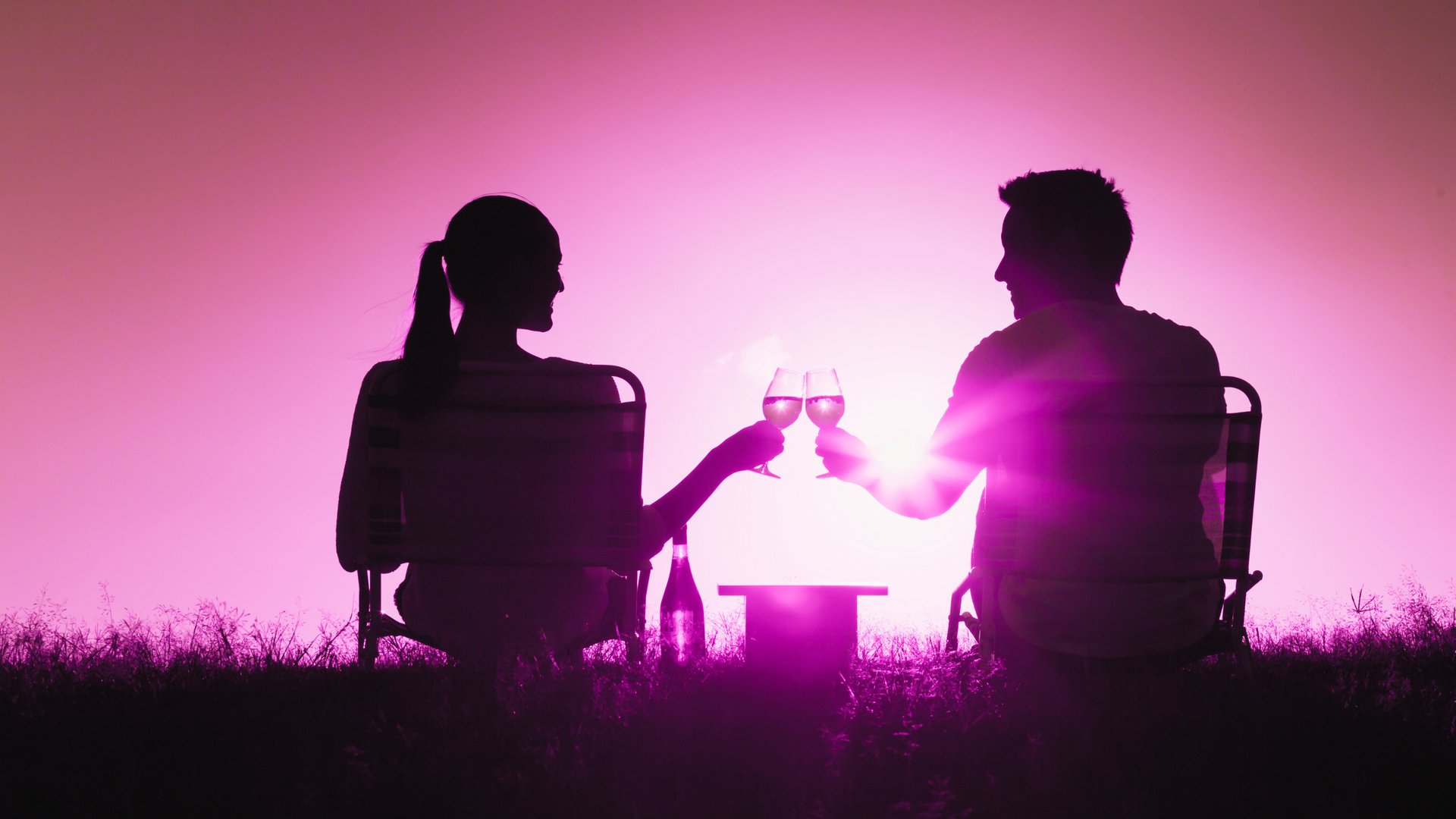A woman in a bikini and sunglasses is standing in front of a pile of wedding dresses.