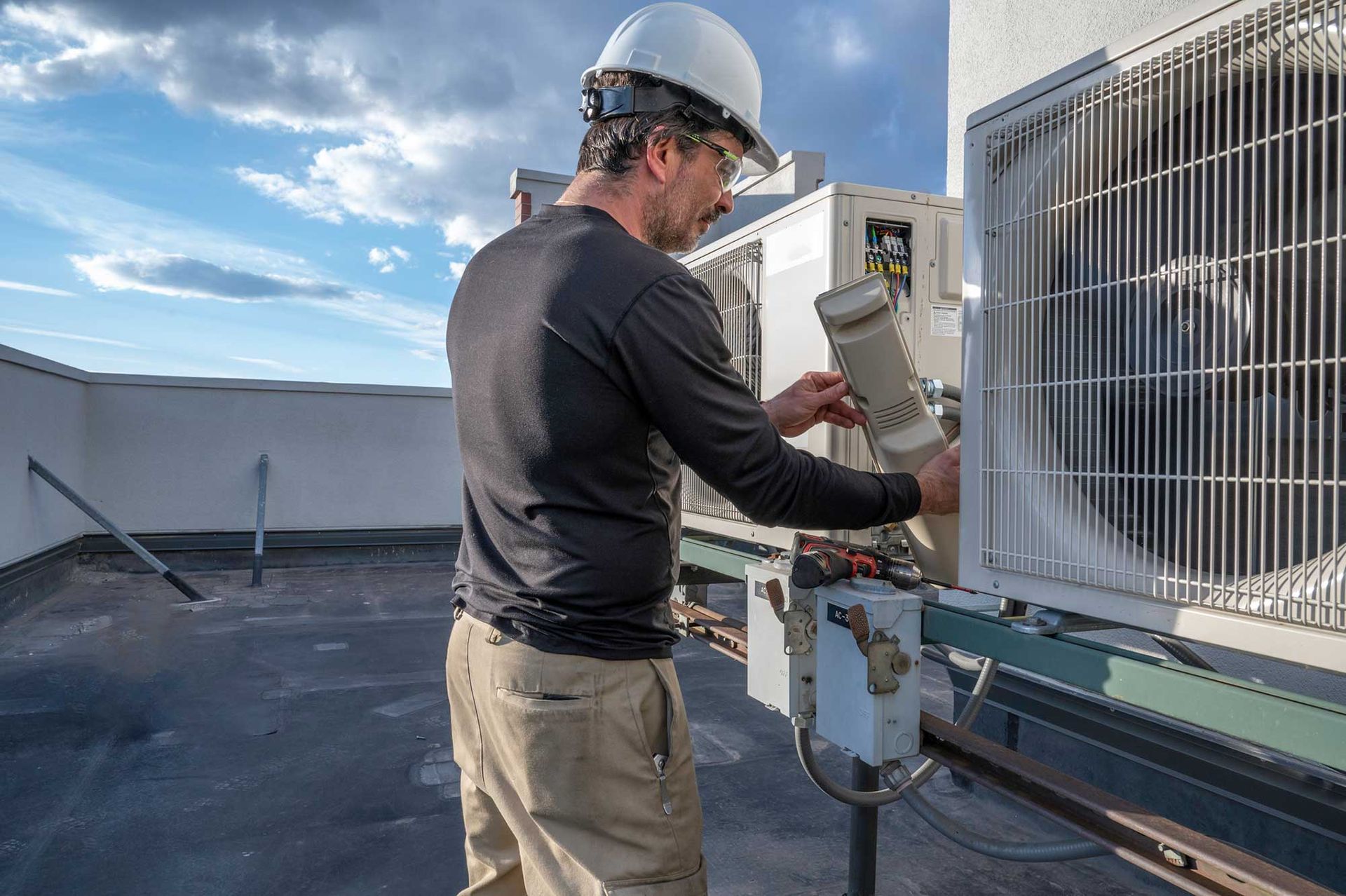 HVAC Technician Checking Air Conditioning System — Kansas City, MO — JLH Mechanical Inc.