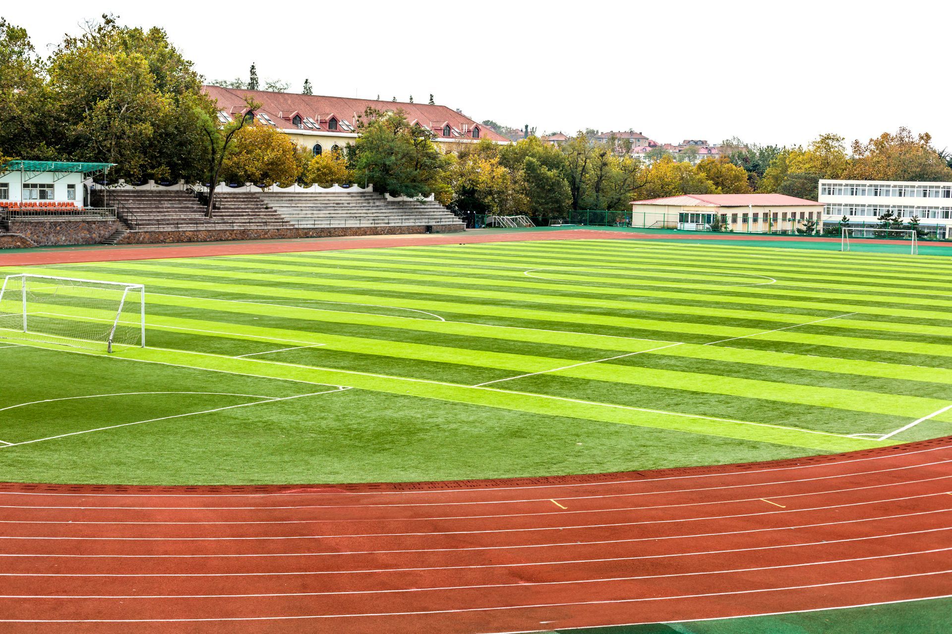 A soccer field with a track in the middle of it.
