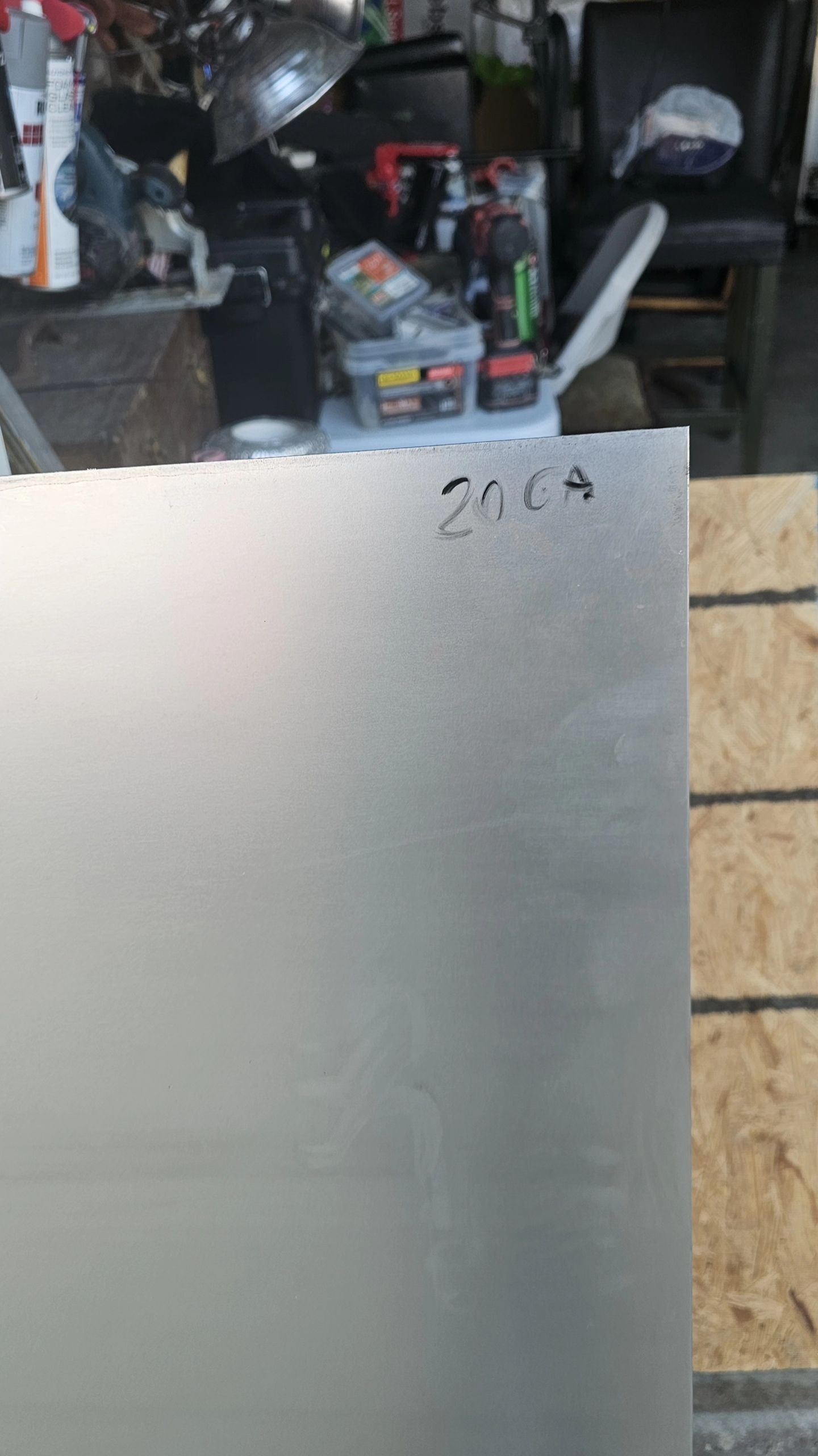 Four bundles of insulation in plastic wrap, stacked on a floor in a room.