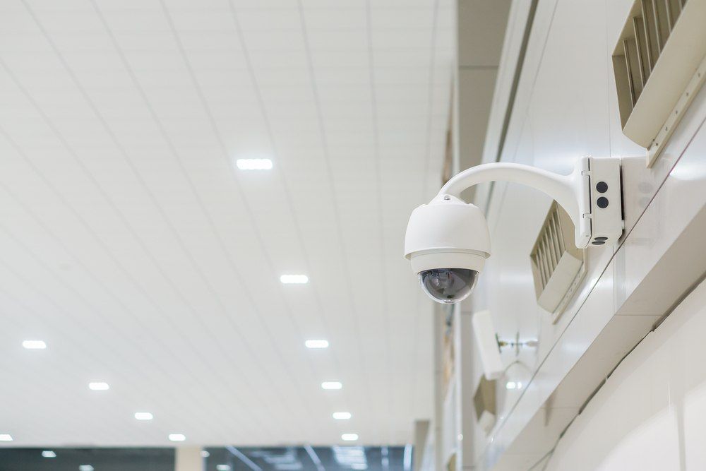 Security Camera Mounted on a White Wall in a Building — X-Mod Security In Landsborough, QLD