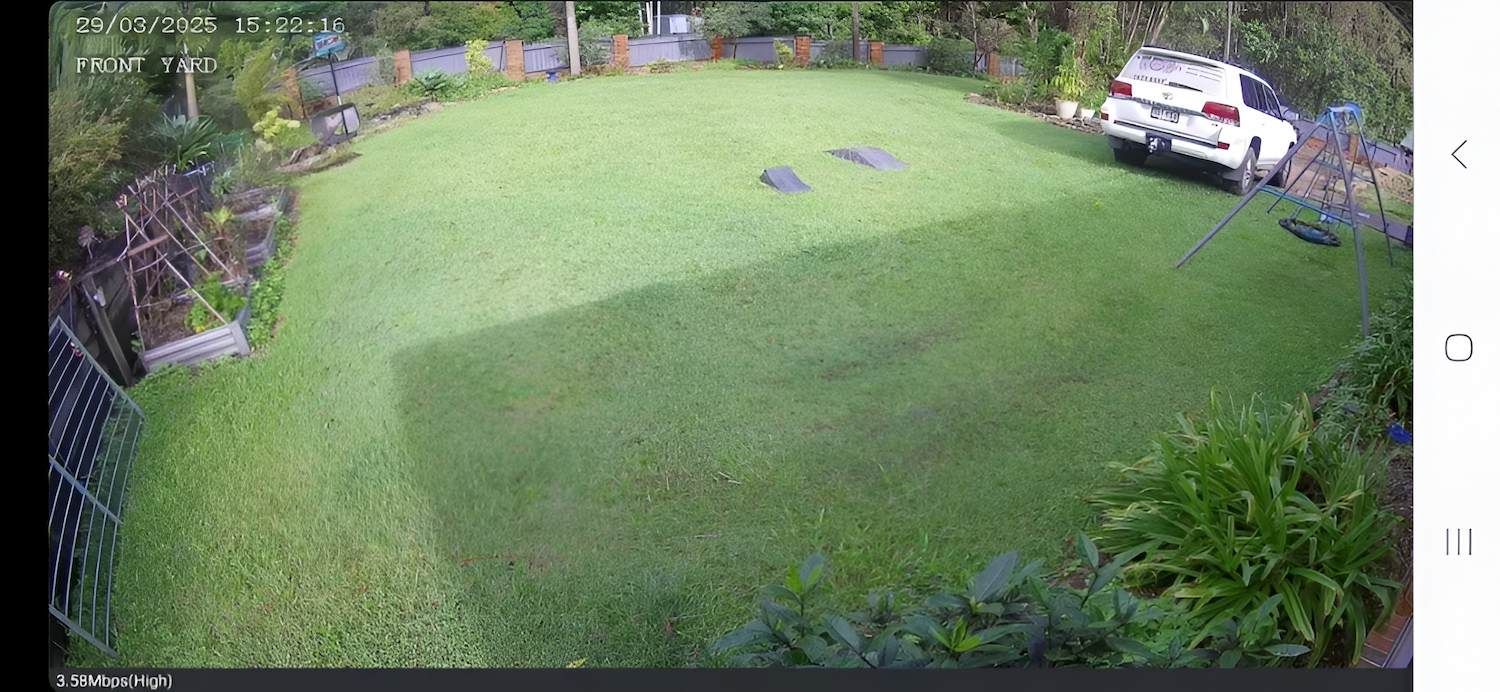 Green Backyard With a White Car Parked on the Grass — X-Mod Security In Landsborough, QLD
