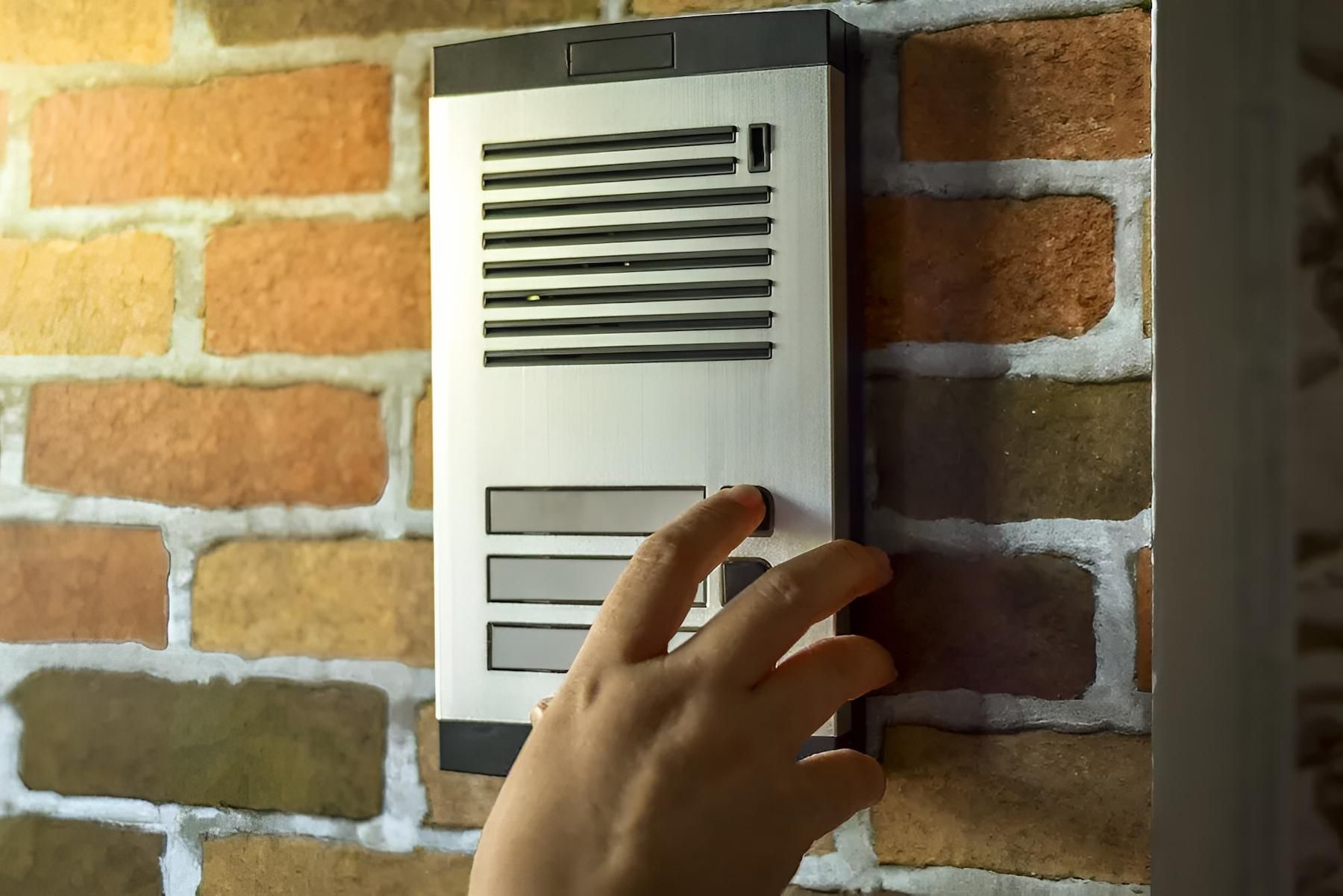 Hand Pressing a Button on a Silver and Black Intercom — X-Mod Security In Landsborough, QLD
