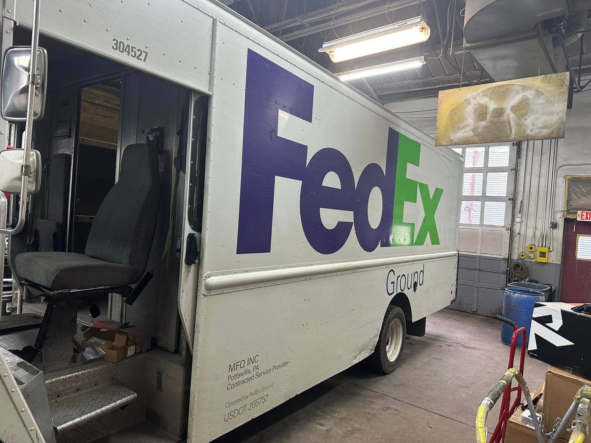 A fedex truck is parked in a garage.