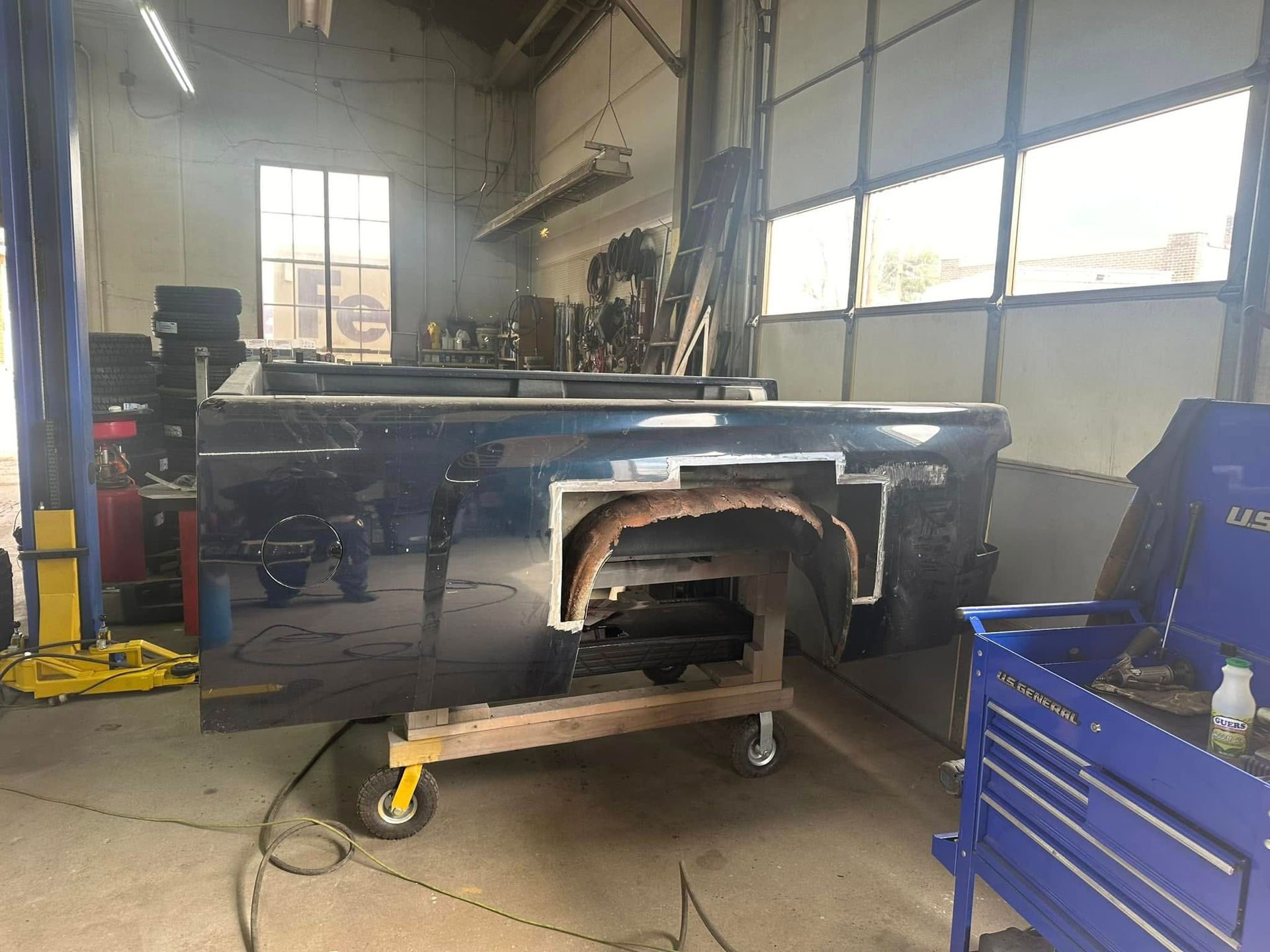 A truck is being worked on in a garage.