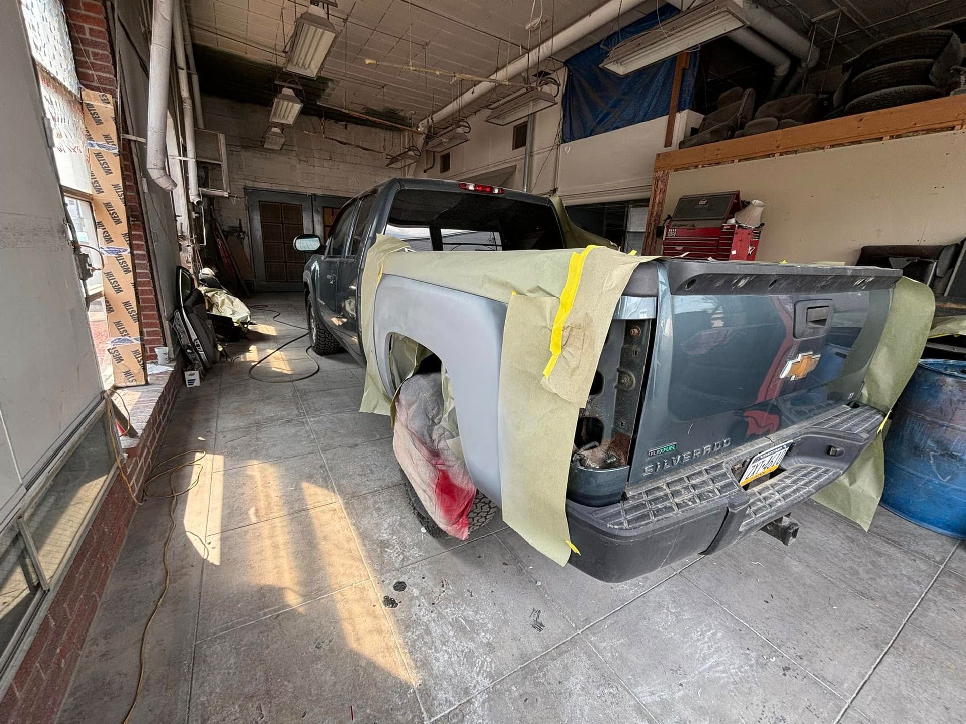 A truck is being worked on in a garage.