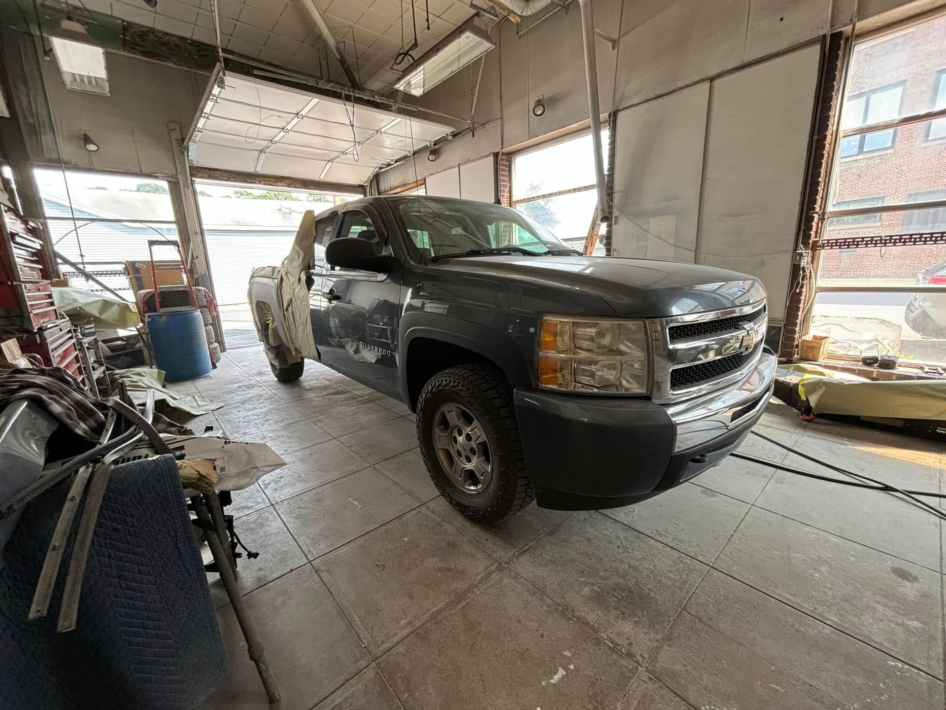 A gray truck is parked in a garage.