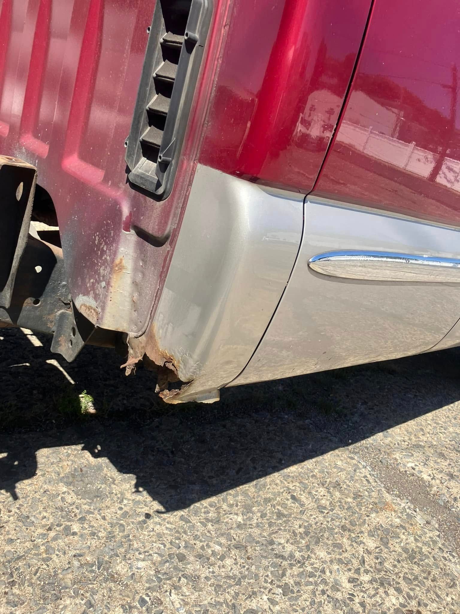 A red truck is parked on the side of the road.