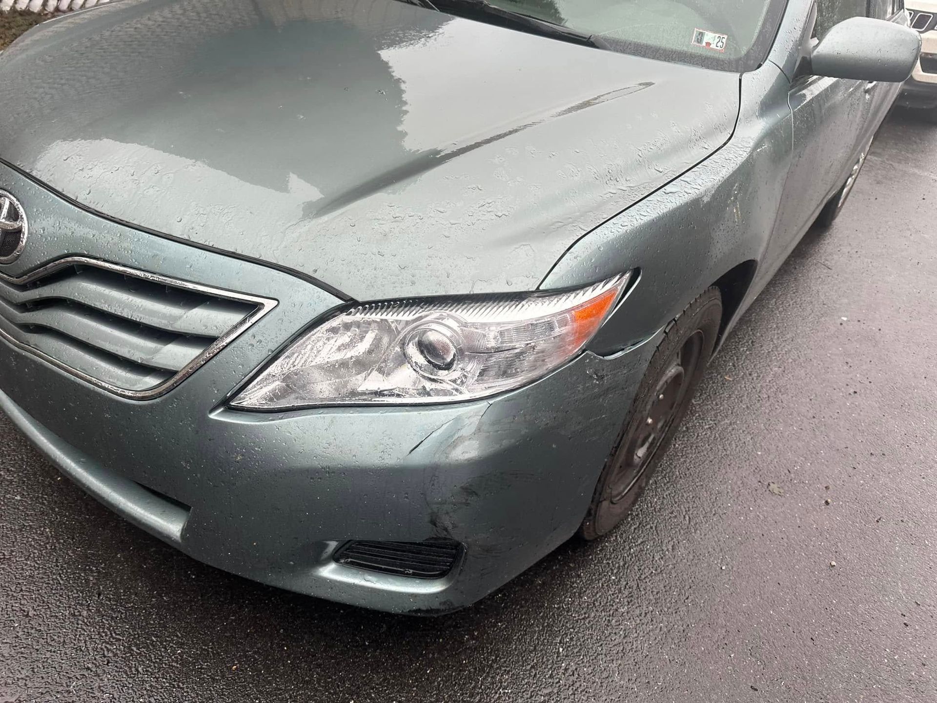A toyota camry is parked on the side of the road.