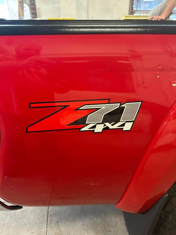 A red truck with a z71 4x4 logo on the side.