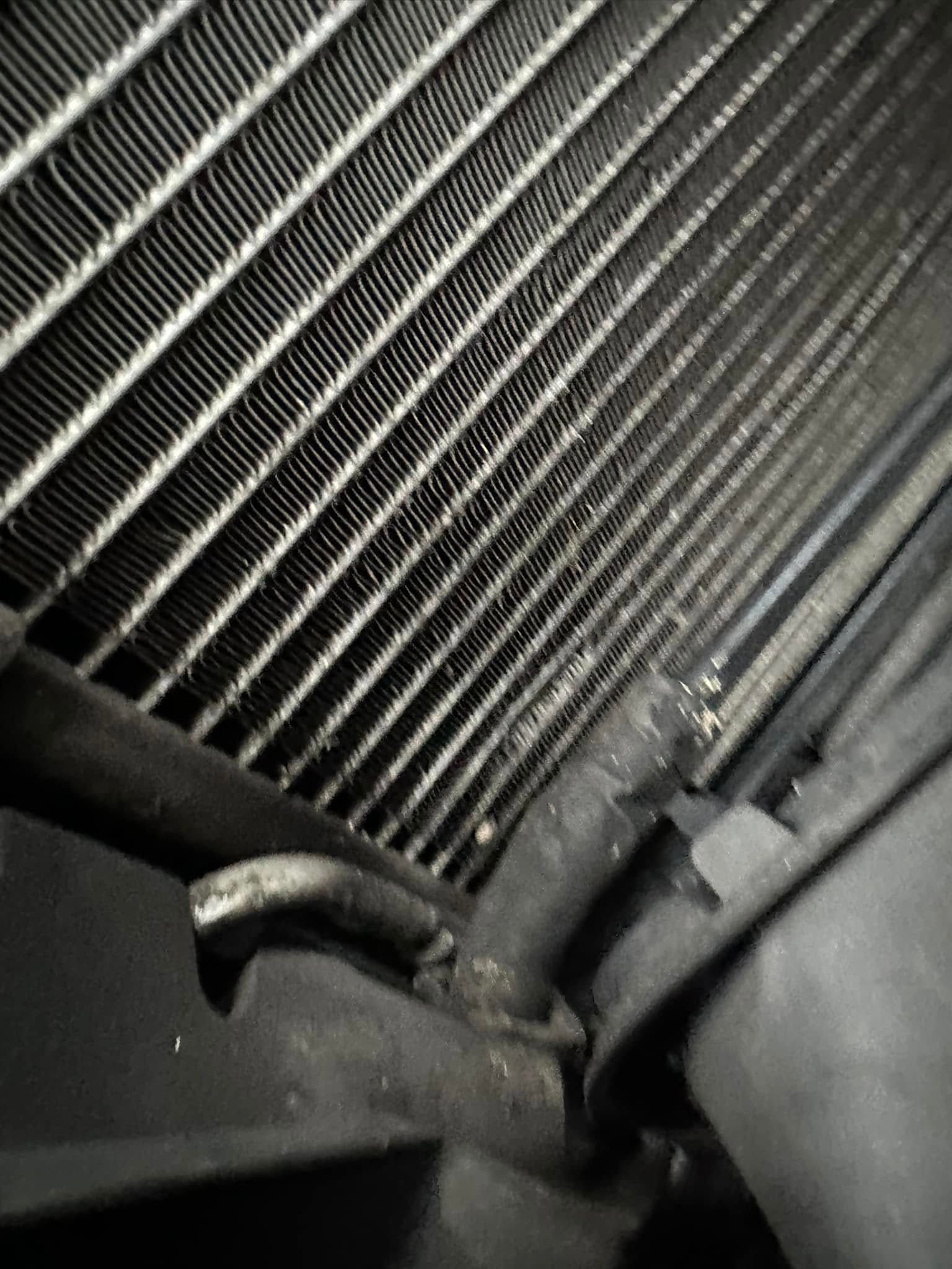 A black and white photo of a radiator on a car.