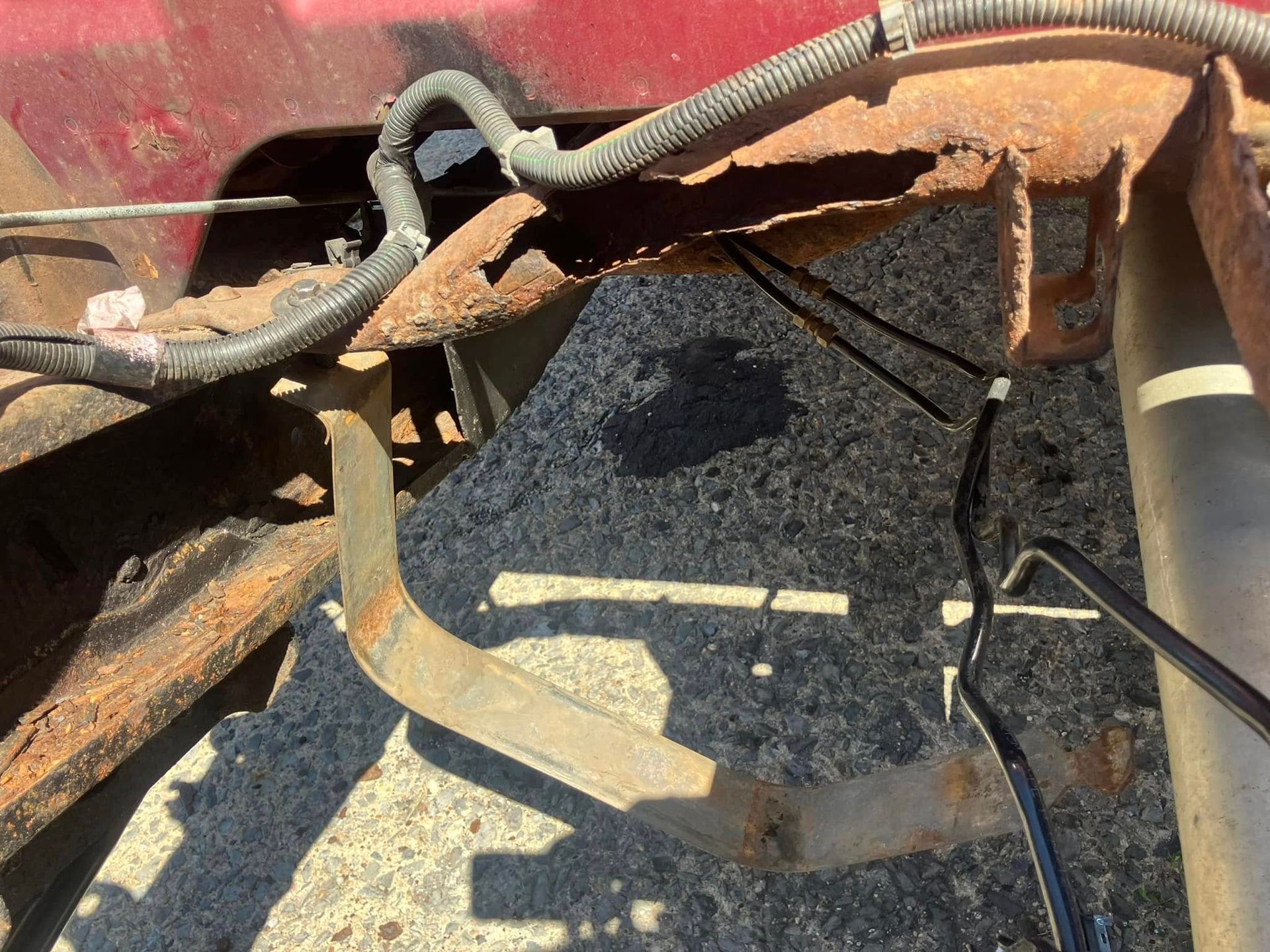 A close up of a rusty piece of metal on the ground