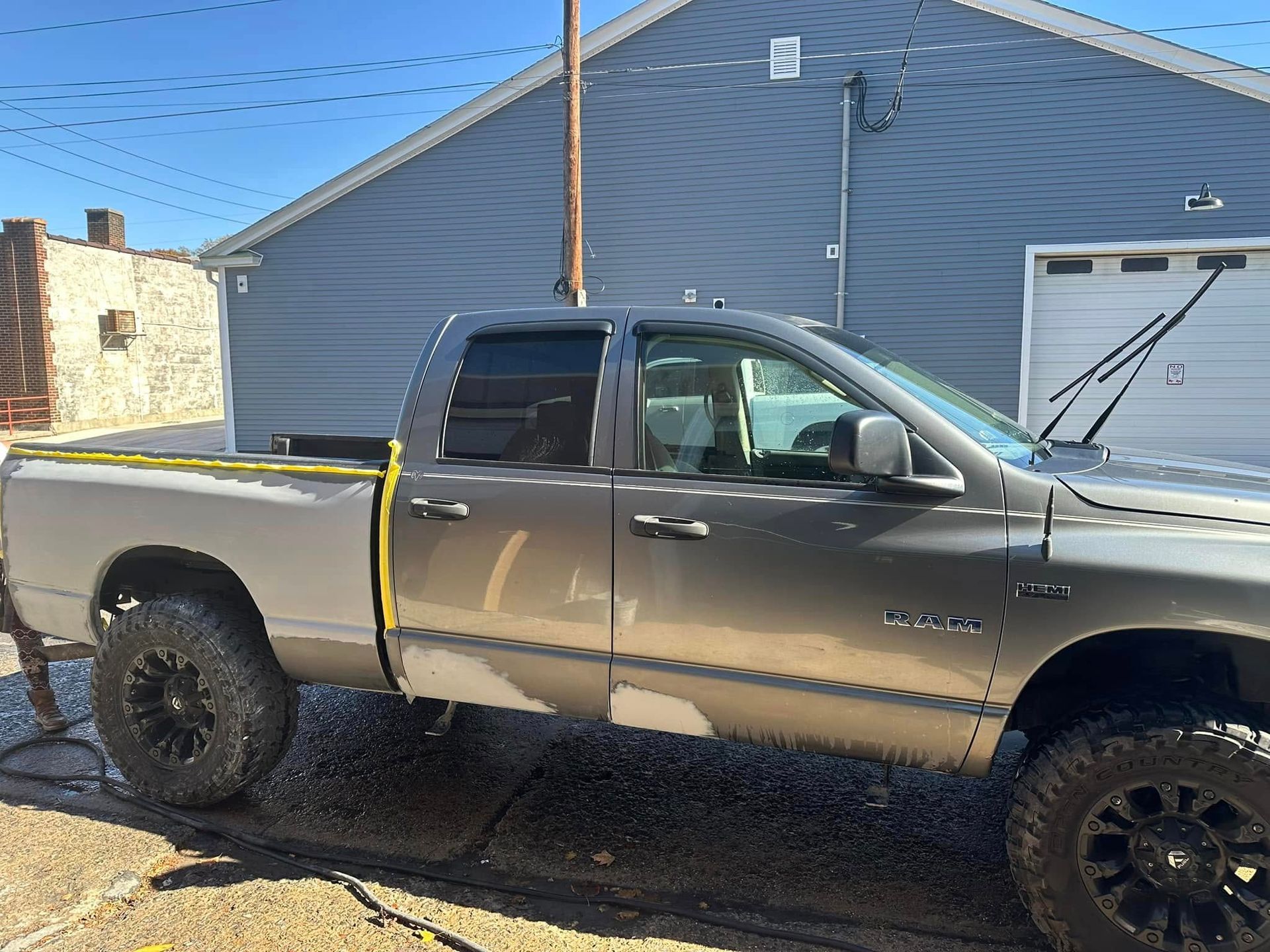 A silver truck is parked in front of a house.