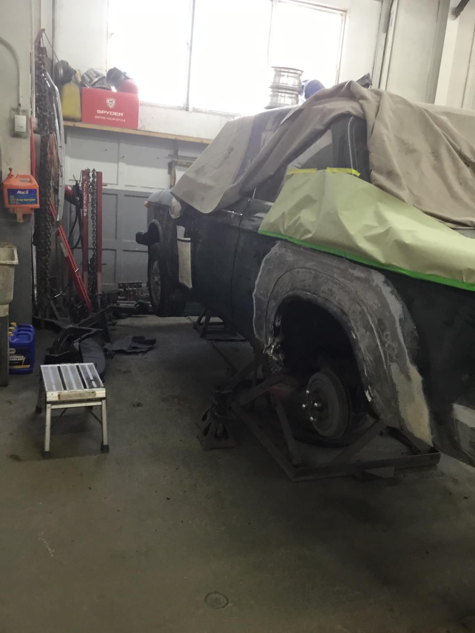 A truck is being worked on in a garage