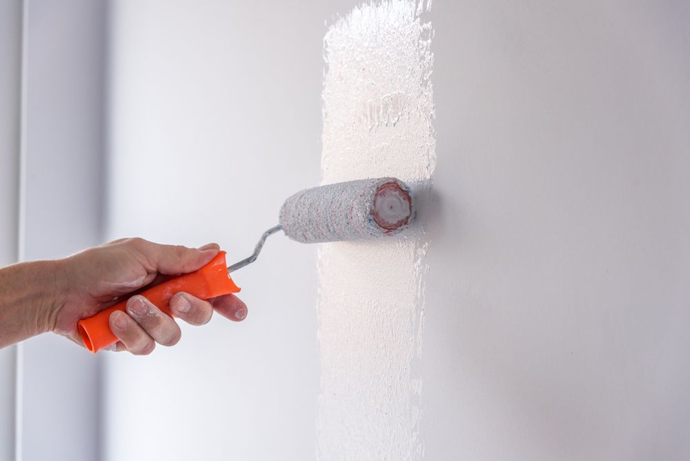 Hand Painting a White Wall — Israel Jones Painting in Vincent, QLD