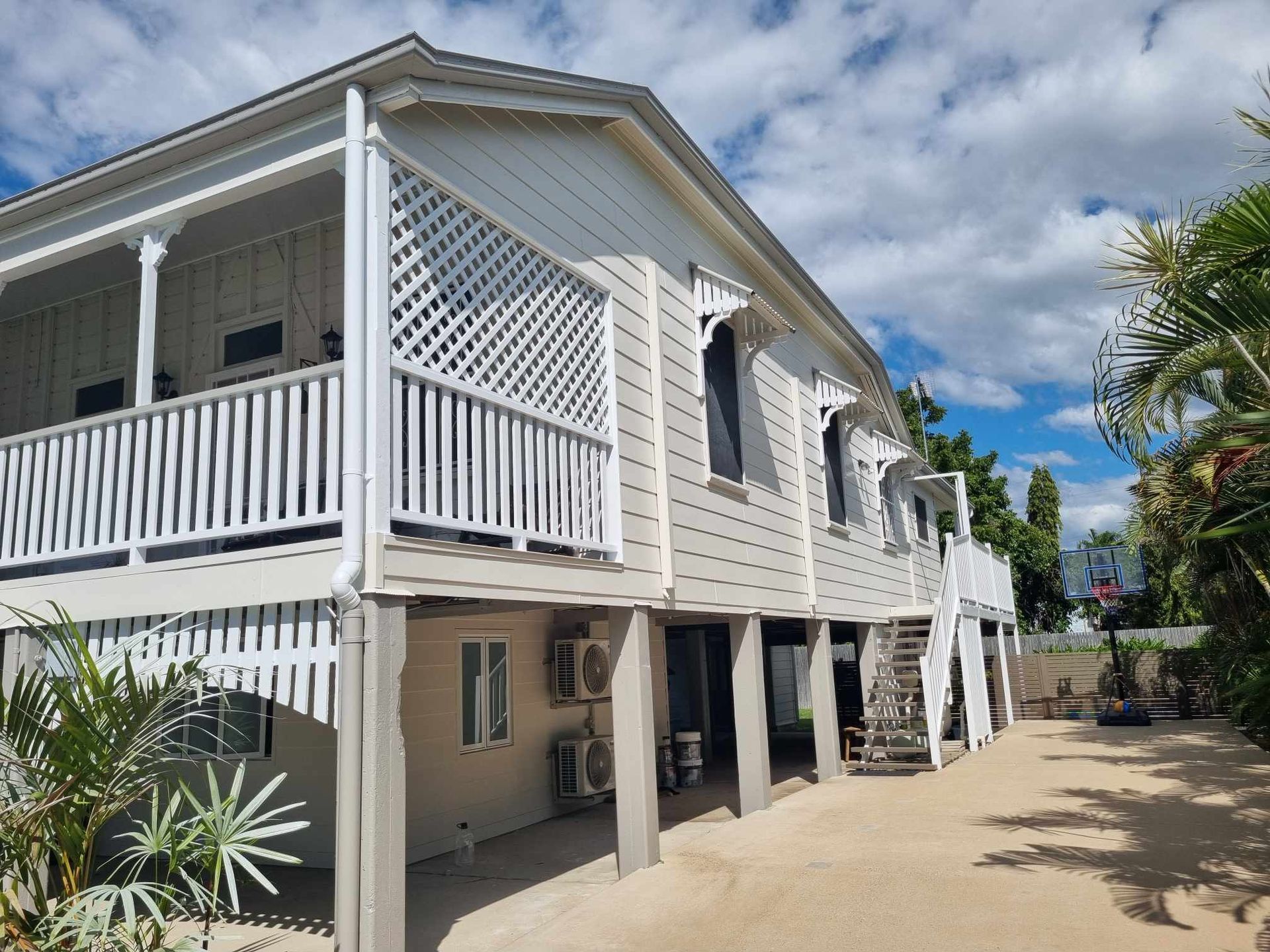 Two-story Beige House With White Trim, Veranda — Israel Jones Painting in Pallarenda, QLD