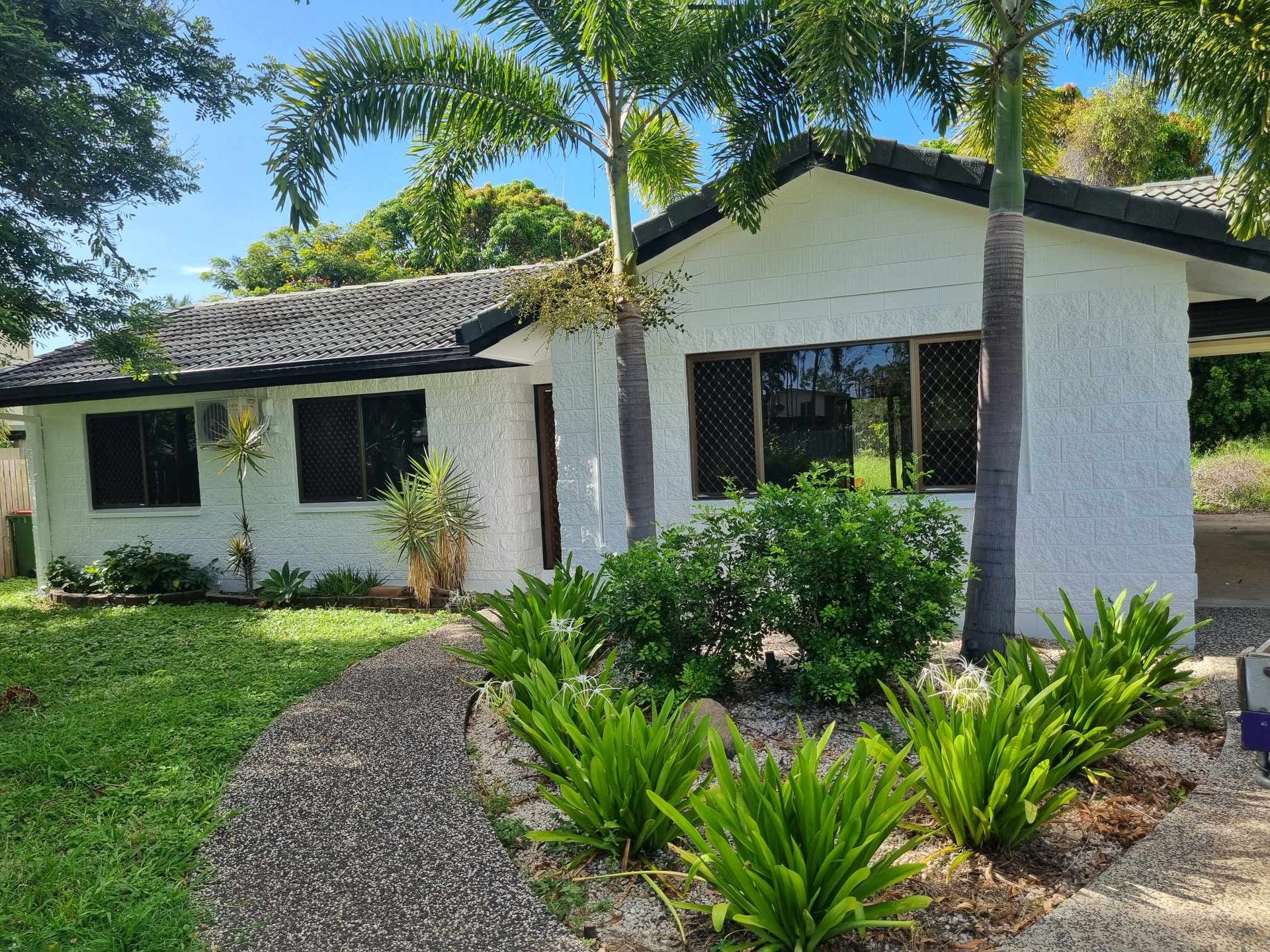 White Stucco House With a Thatched Roof — Israel Jones Painting in Vincent, QLD
