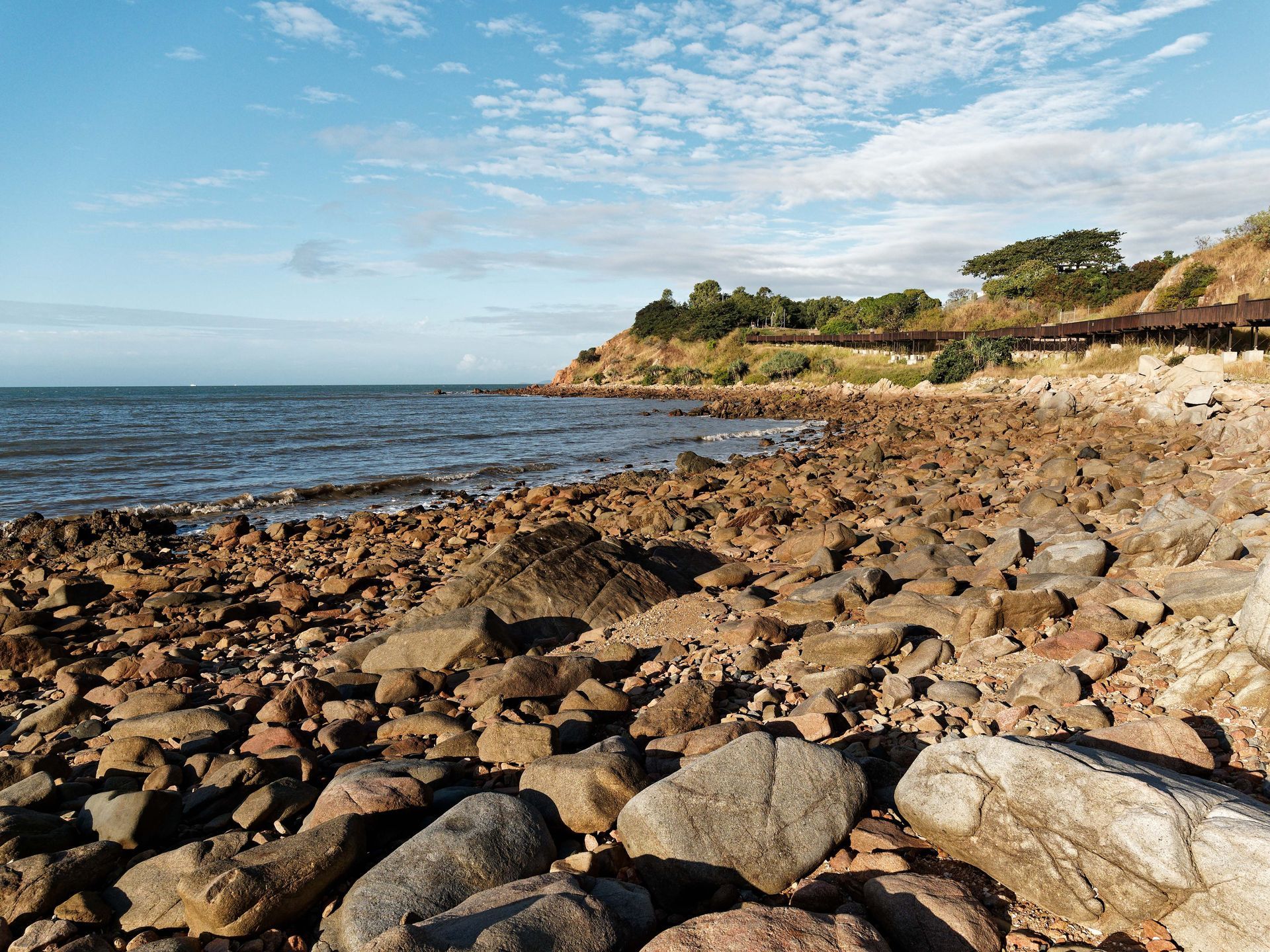 Rocky Shoreline With Ocean and Hill — Israel Jones Painting in Rowes Bay