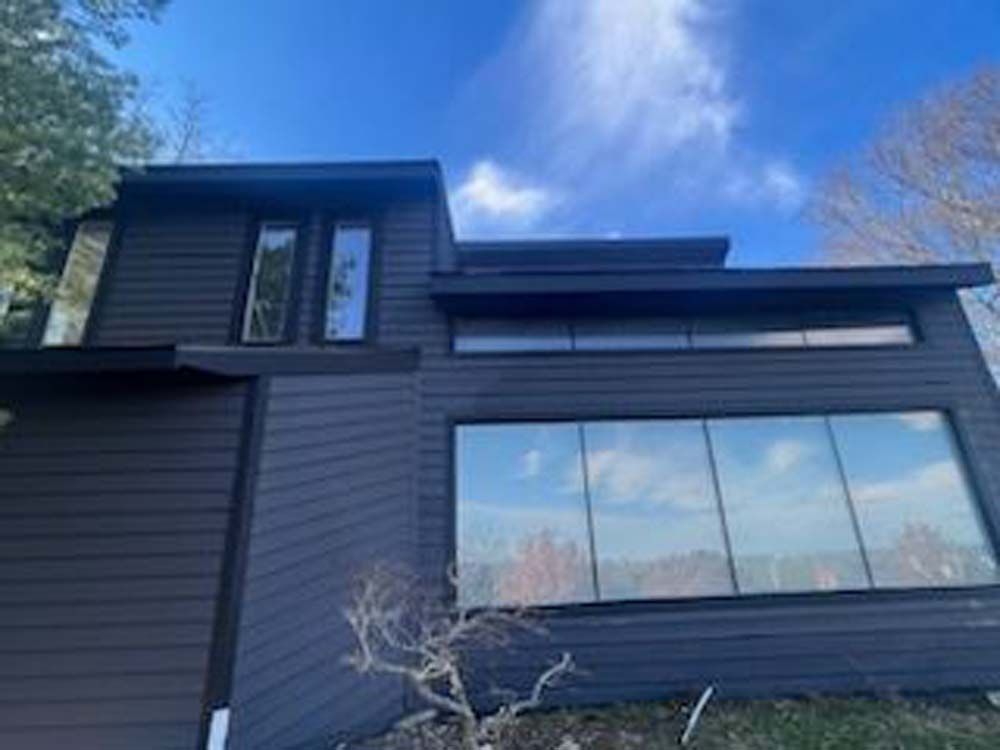 A large house with a lot of windows and a blue sky in the background.