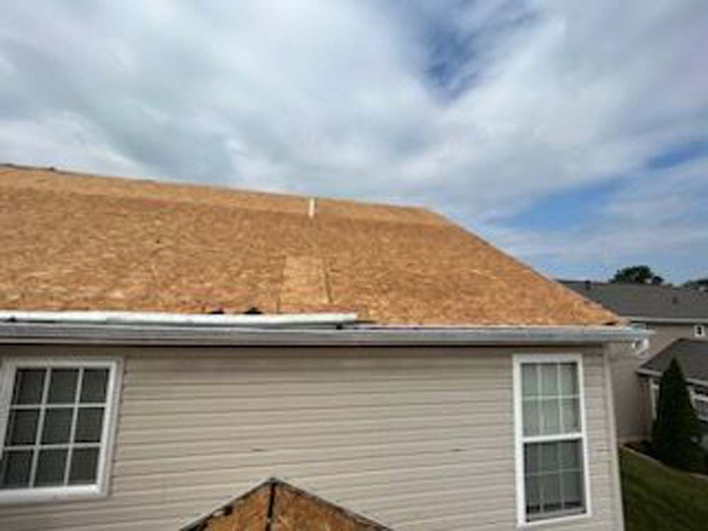 A house with a roof that is being installed.