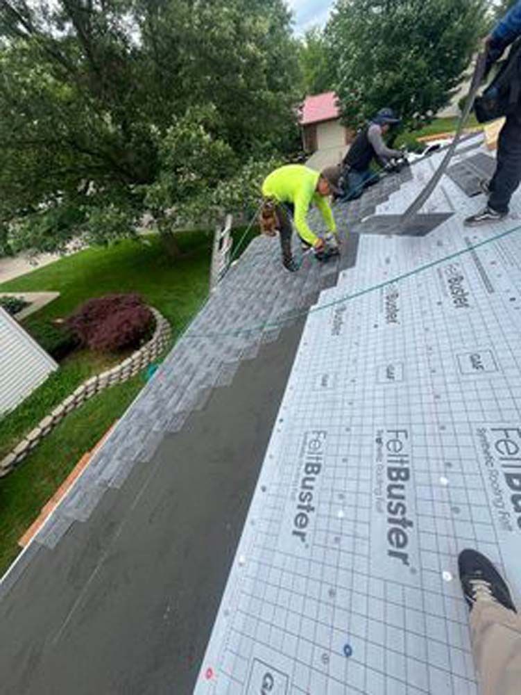 A group of people are working on a roof.