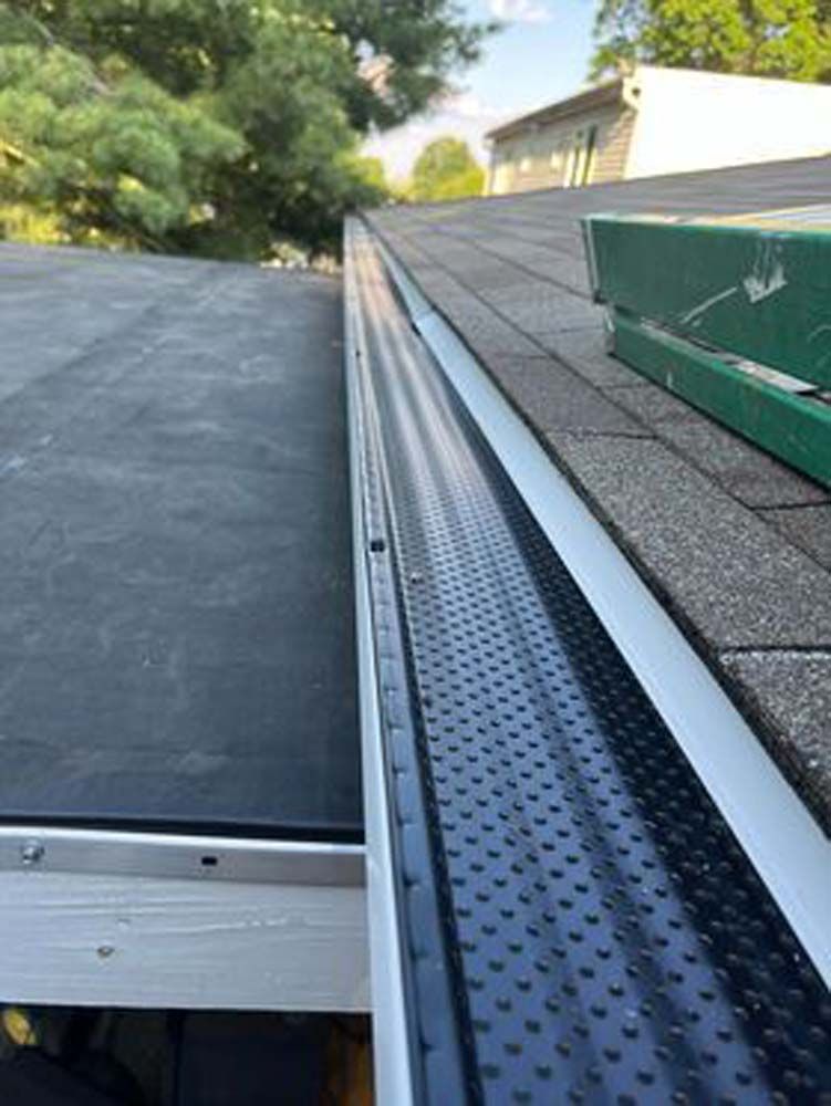 A close up of a gutter on a roof.