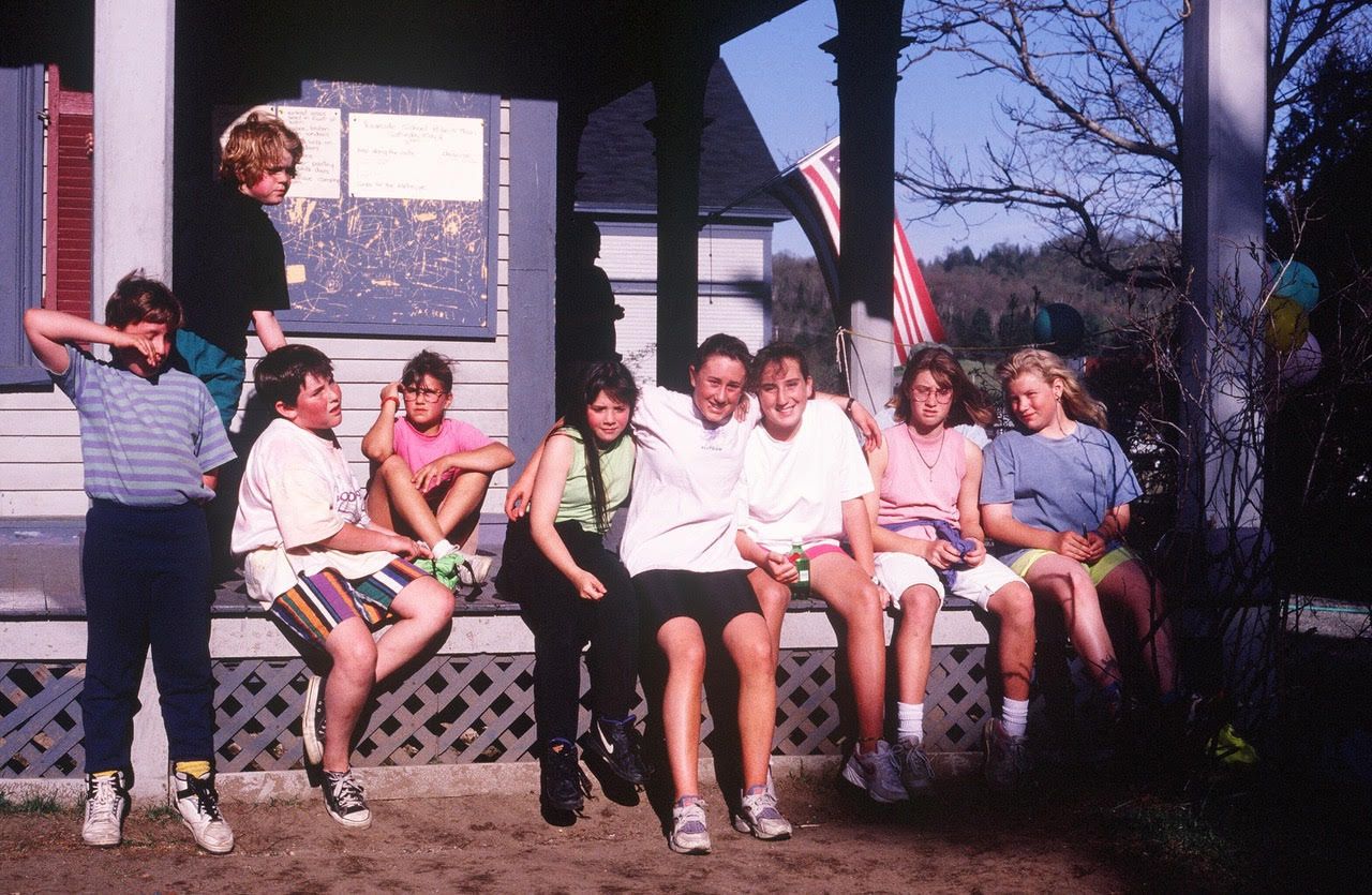 Students sitting on porch of the Riverside School