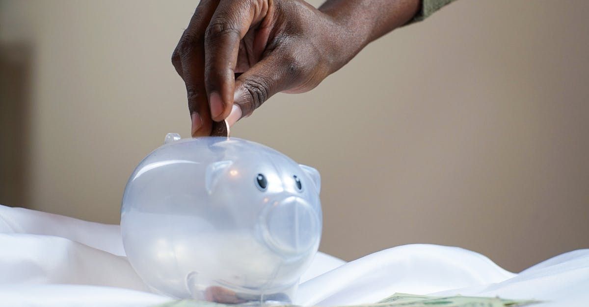 Someone putting money in a piggy bank.