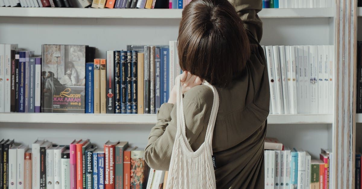 A women reaching for a book on a bookshelf.