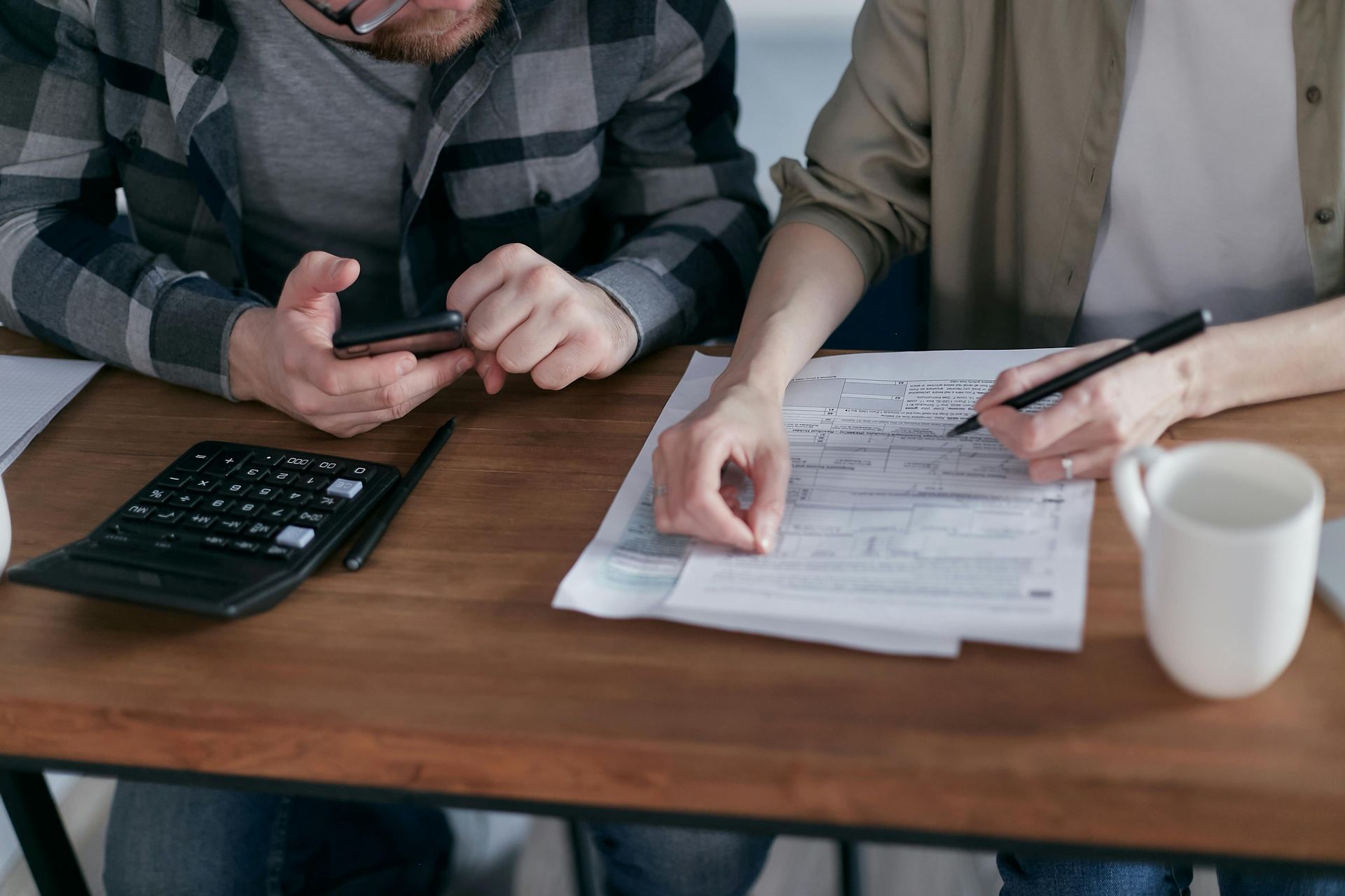 A couple reviewing their finances at a desk.