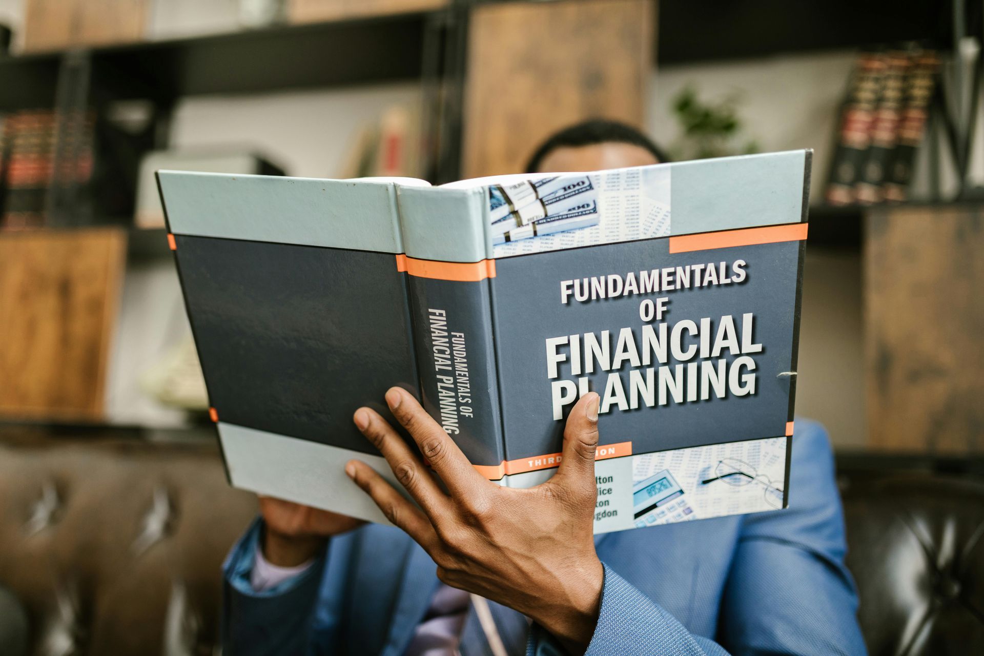 A man reading the Fundamentals of Financial Planning.