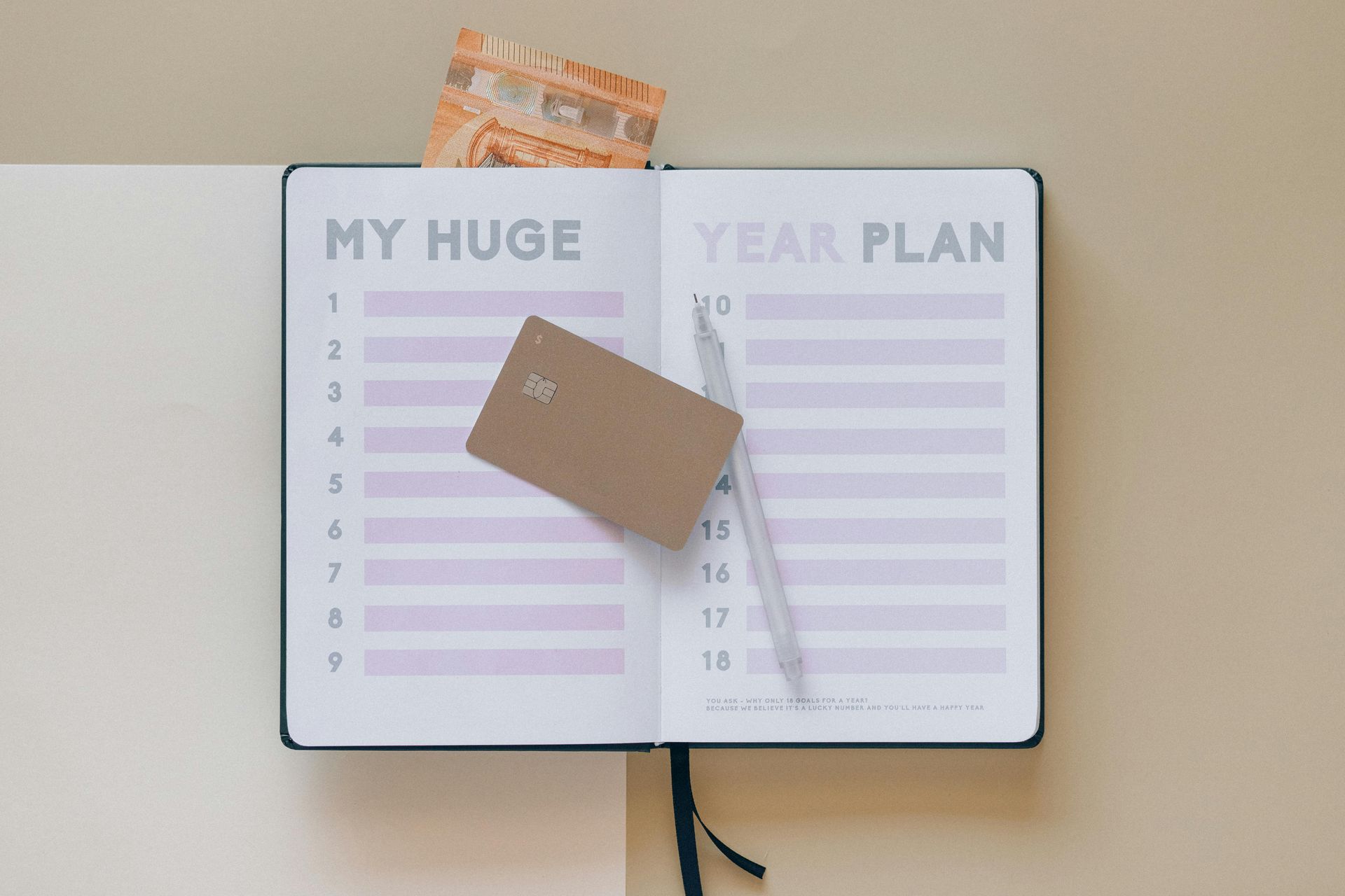 A planner with a credit card on top.