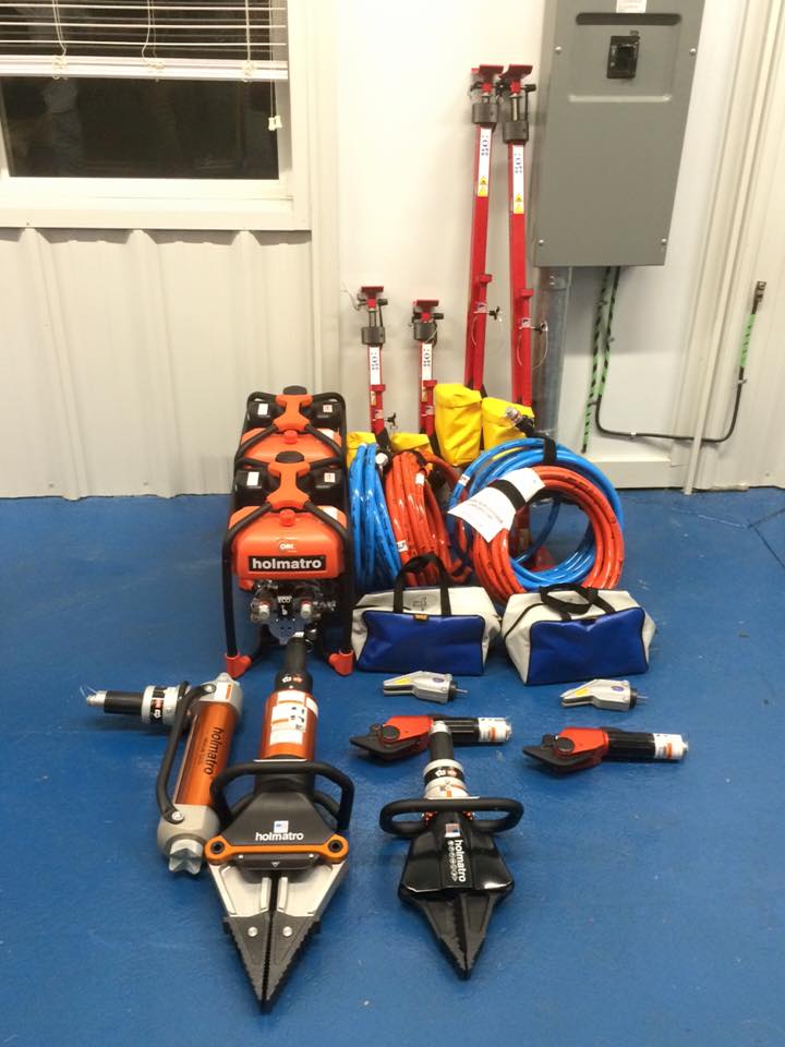 A bunch of tools are sitting on a blue floor