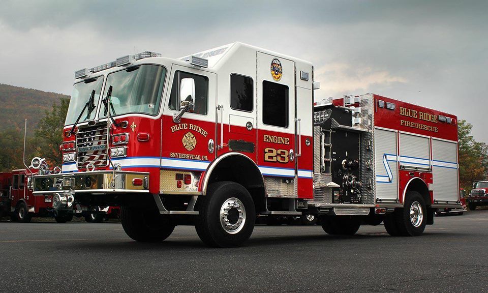 A red and white fire truck with the number 23 on it